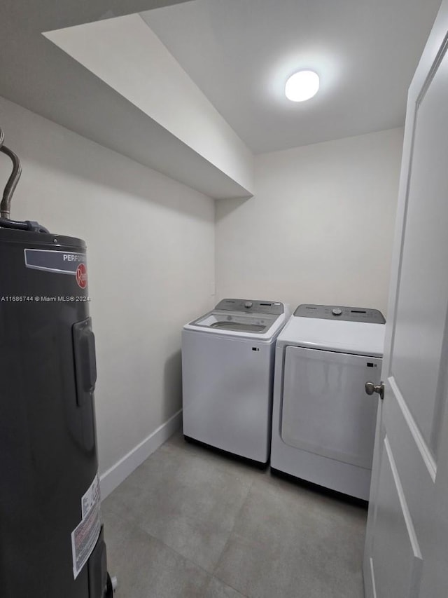 clothes washing area featuring water heater and washing machine and dryer