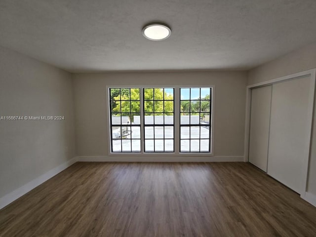 spare room featuring dark hardwood / wood-style floors