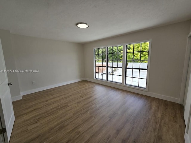 empty room with dark hardwood / wood-style floors