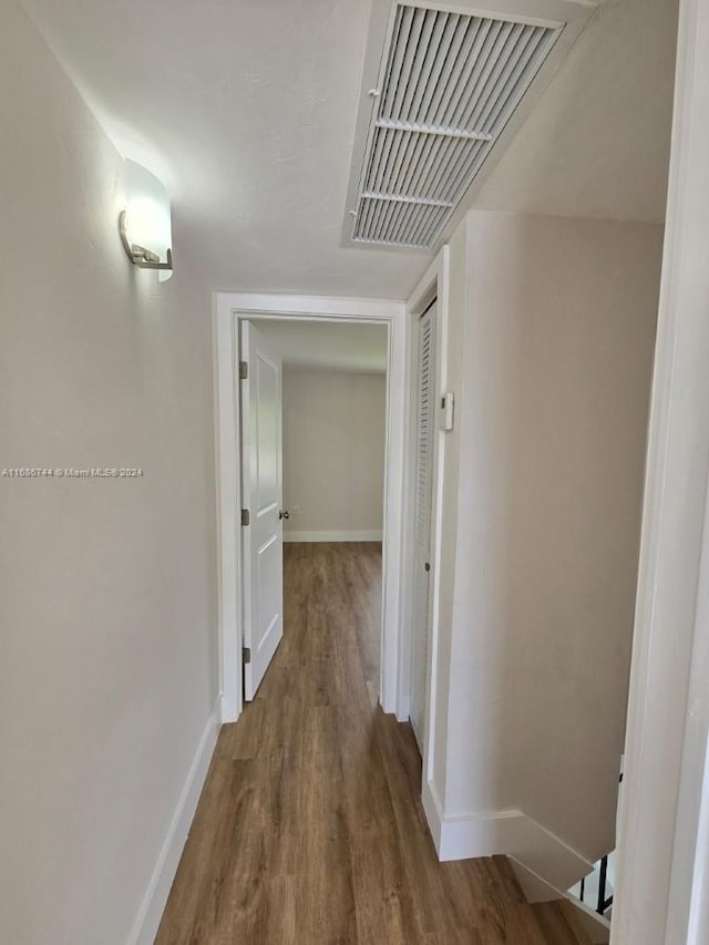 hall with hardwood / wood-style flooring