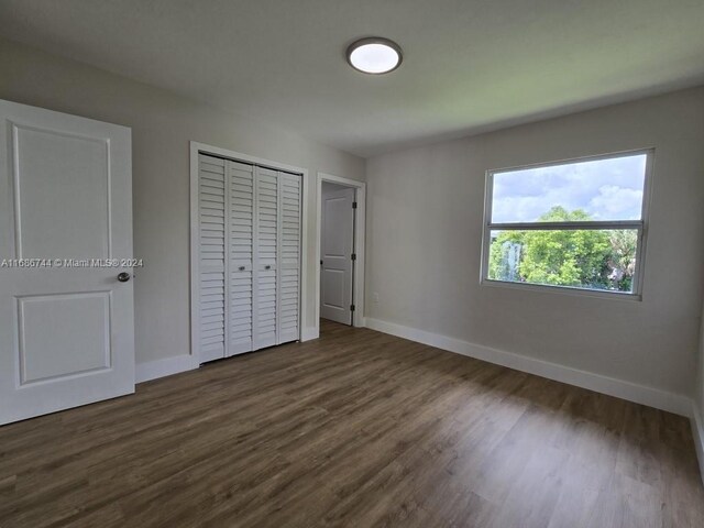 unfurnished bedroom featuring dark wood-type flooring