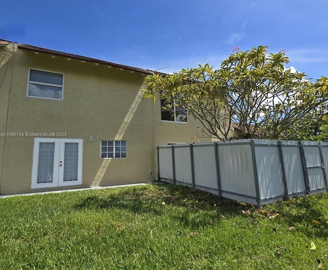 view of side of home with a lawn