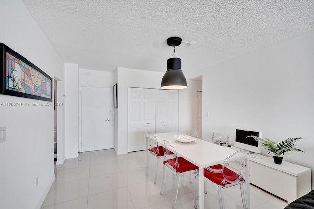 dining space with a textured ceiling