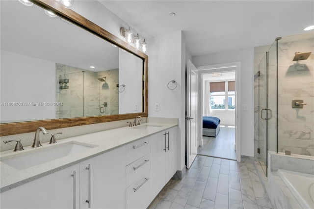 bathroom featuring vanity and separate shower and tub