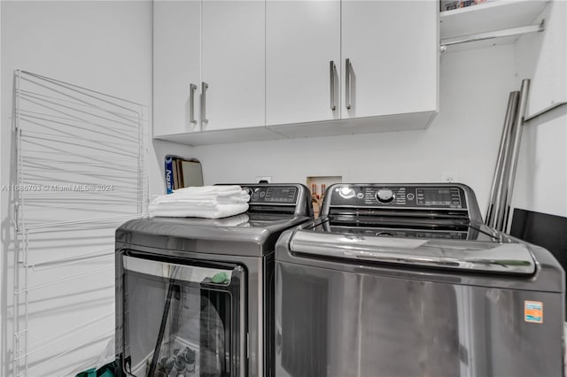 washroom with cabinets and independent washer and dryer