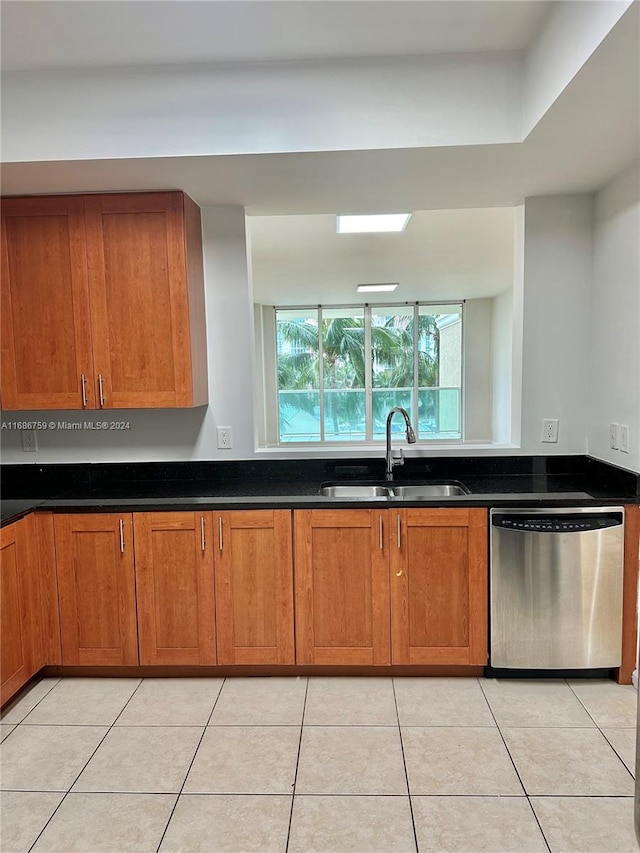 kitchen with light tile patterned flooring, sink, and stainless steel dishwasher