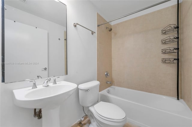 bathroom featuring toilet and tiled shower / bath combo