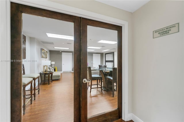 hallway featuring french doors and hardwood / wood-style flooring