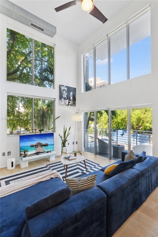 900 4th St Unit 3, Miami Beach, FL 33139 - living room featuring a high ceiling, wood finished floors, healthy amount of natural light, and ceiling fan