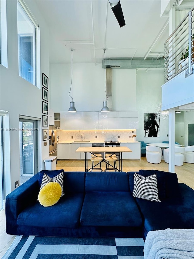 living room featuring hardwood / wood-style flooring and a high ceiling