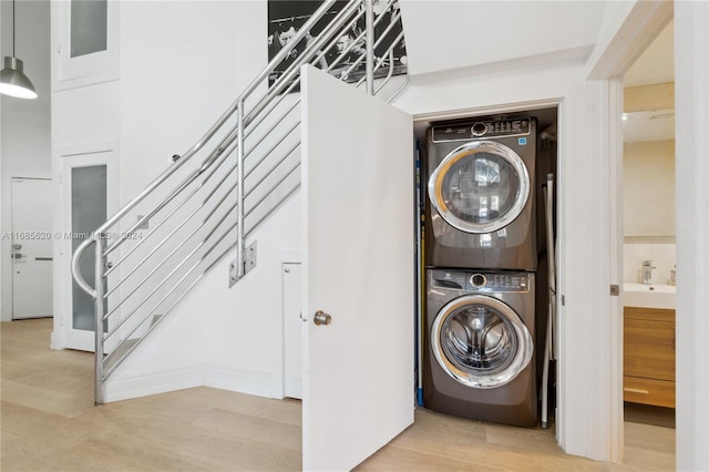 900 4th St Unit 3, Miami Beach, FL 33139 - laundry area with estacked washer and dryer and wood finished floors