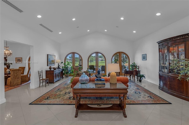 tiled living room featuring french doors, high vaulted ceiling, and an inviting chandelier