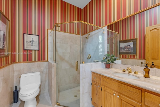 bathroom featuring vanity, toilet, and a shower with shower door