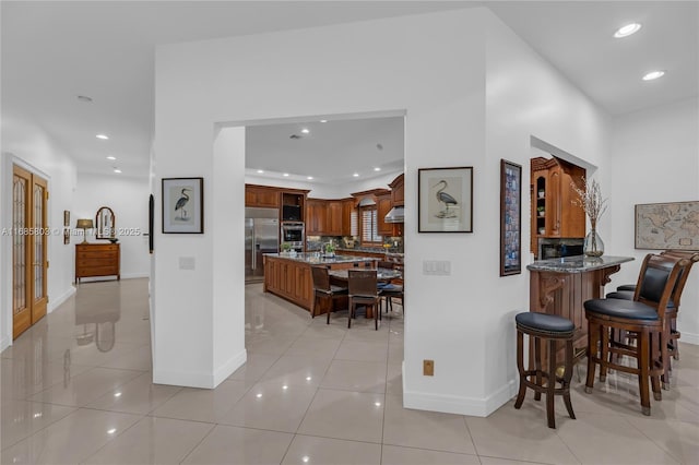 hallway featuring light tile patterned floors