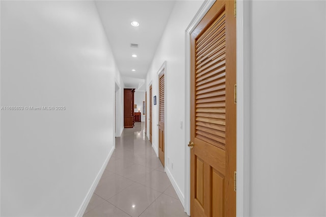 hall with light tile patterned floors