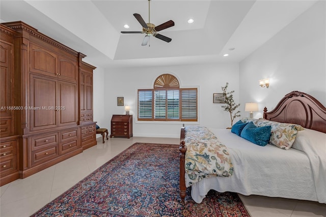 bedroom featuring a tray ceiling, ceiling fan, and light tile patterned floors