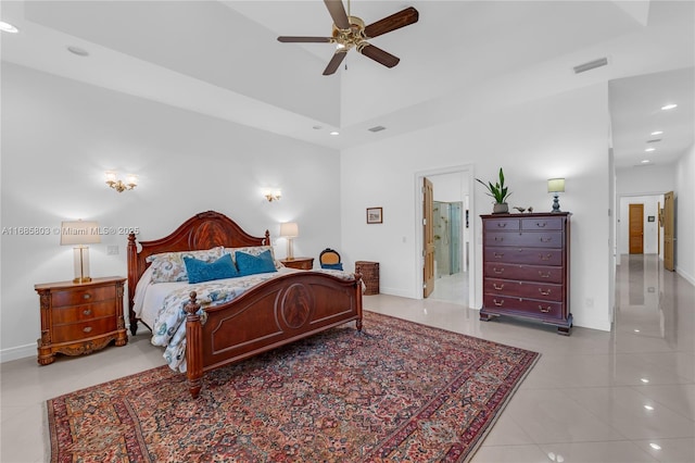 bedroom with light tile patterned floors, connected bathroom, and ceiling fan