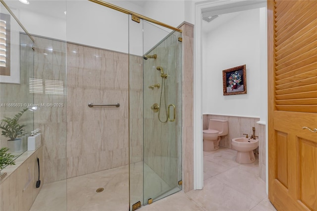 bathroom with a shower with door, a bidet, and toilet