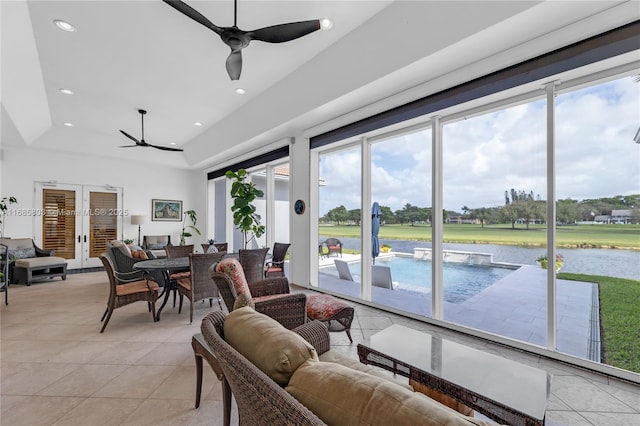 living room featuring a raised ceiling, ceiling fan, french doors, and light tile patterned flooring