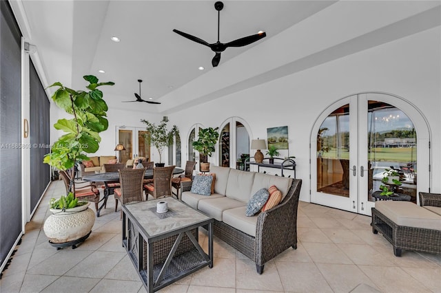 tiled living room featuring french doors and ceiling fan