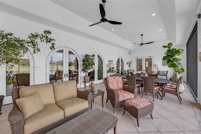 interior space with a tray ceiling, a wealth of natural light, and french doors