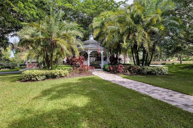 view of front of property with a front yard and a gazebo