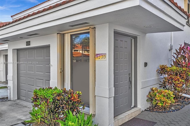 doorway to property featuring a garage