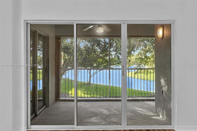 entryway featuring a water view and ceiling fan