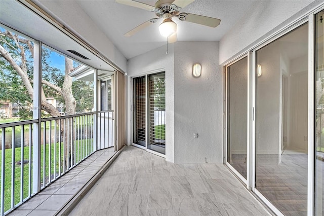 unfurnished sunroom with a ceiling fan