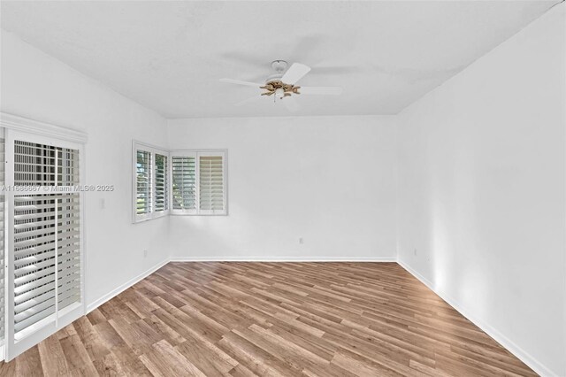 empty room with light hardwood / wood-style floors and ceiling fan