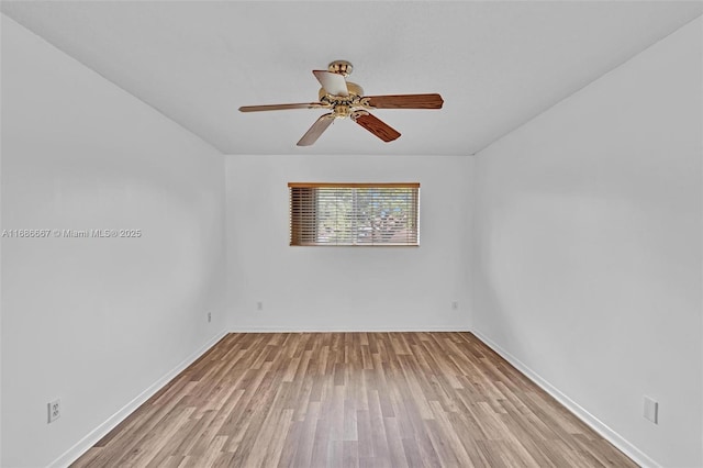 empty room with baseboards, ceiling fan, and light wood finished floors