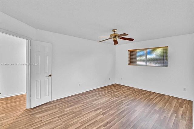 spare room featuring ceiling fan and light wood-type flooring