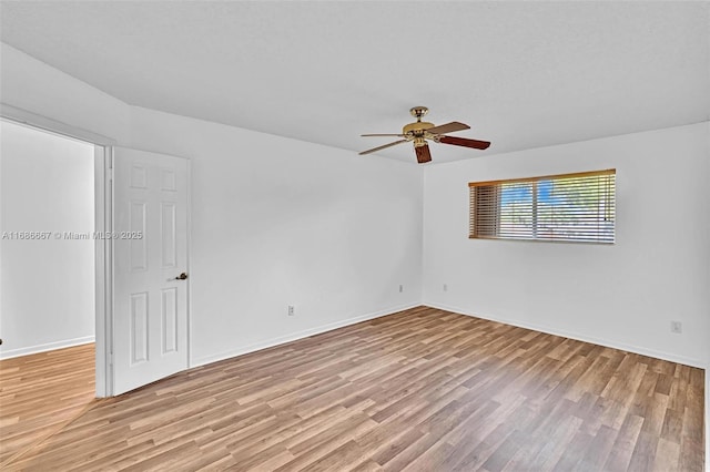 unfurnished room with a ceiling fan, baseboards, and light wood finished floors