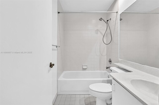 full bathroom with tiled shower / bath, vanity, toilet, and tile patterned flooring