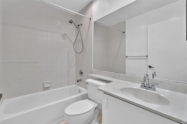 full bathroom featuring vanity, tiled shower / bath, toilet, and tile patterned floors