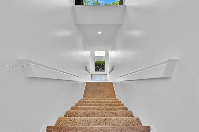 stairs featuring recessed lighting