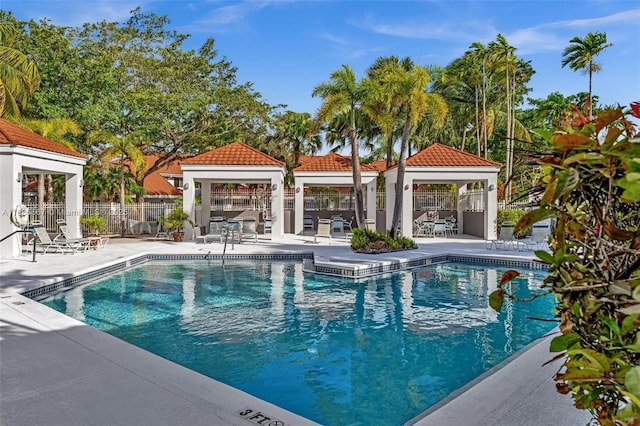 pool featuring a patio area and fence