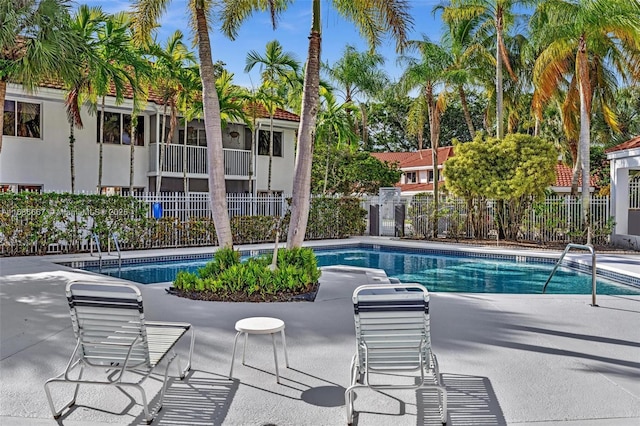 pool featuring a patio area and fence