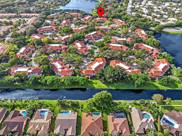 drone / aerial view featuring a water view and a residential view