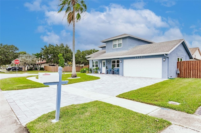 view of front of house featuring a front lawn and a garage