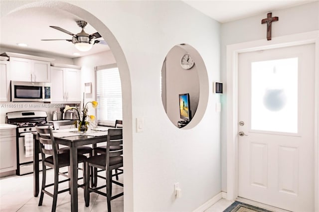 dining room with ceiling fan and light tile patterned floors