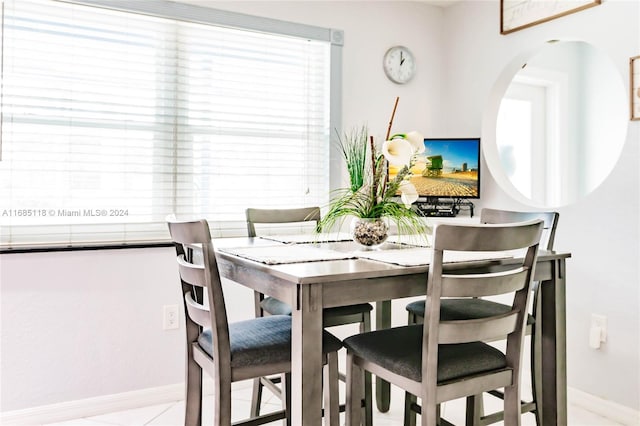 dining area featuring light tile patterned floors