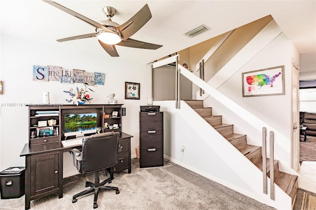 carpeted home office featuring ceiling fan