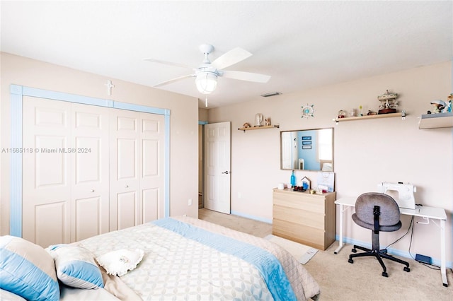 carpeted bedroom featuring ceiling fan and a closet