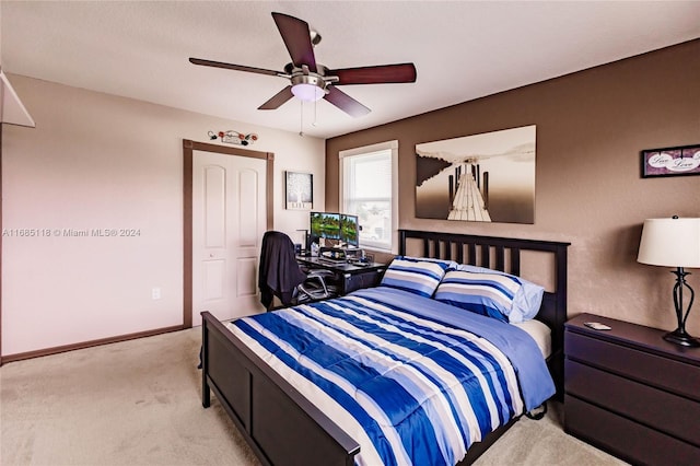 carpeted bedroom featuring ceiling fan and a closet