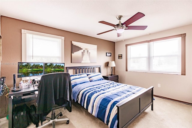 bedroom with ceiling fan and light colored carpet