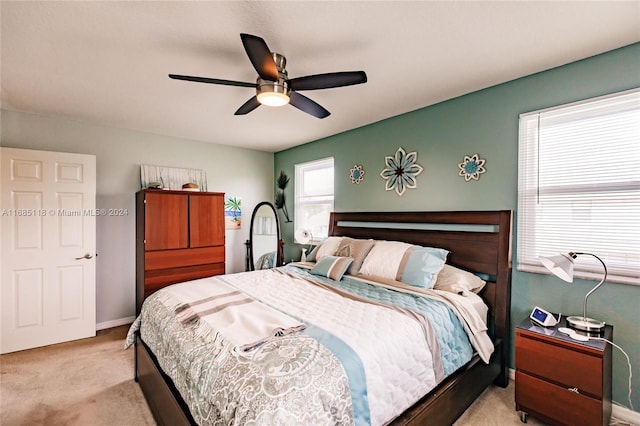 bedroom with light colored carpet and ceiling fan