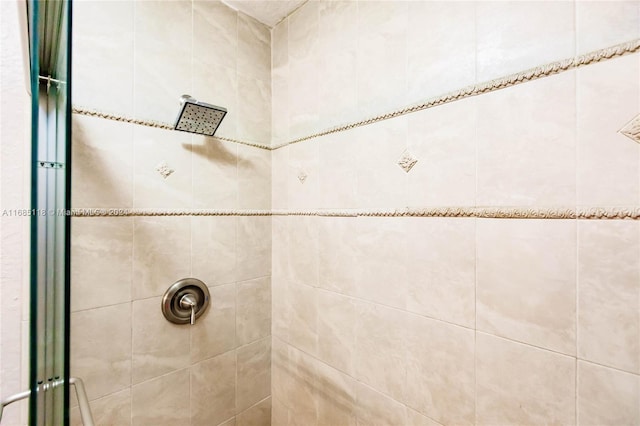 bathroom featuring a shower with door