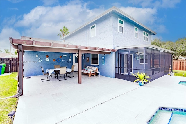 rear view of property featuring a patio area and a sunroom