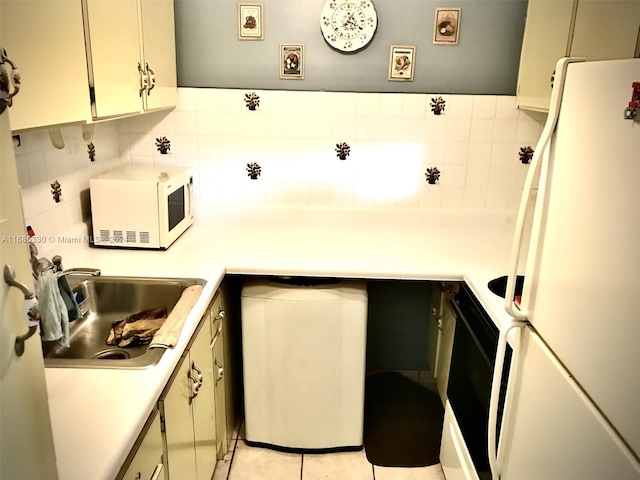 kitchen featuring backsplash, sink, white appliances, and light tile patterned floors